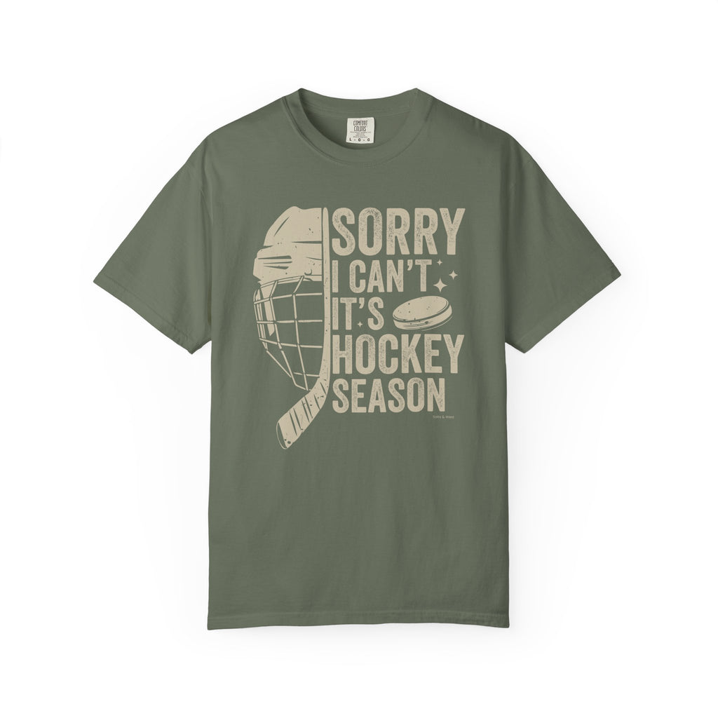 Green t-shirt with hockey-themed graphic and text on a white background