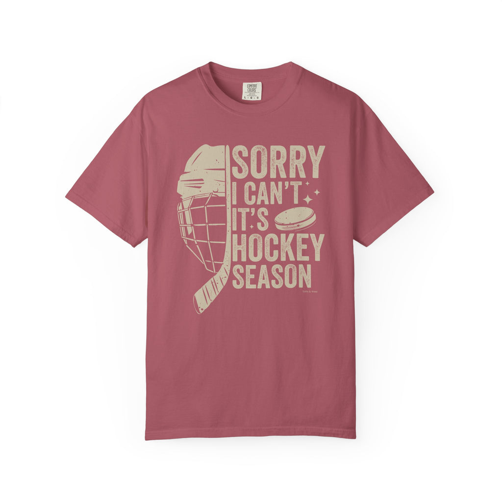 Maroon t-shirt with hockey-themed graphic and text on a white background