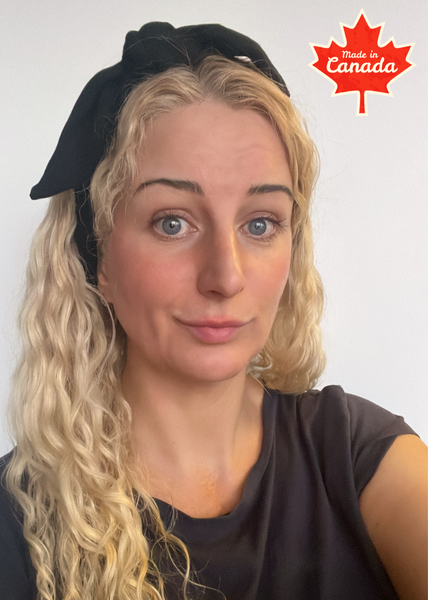 Woman with blonde hair and a black bamboo headband, a made in Canada clothing product.