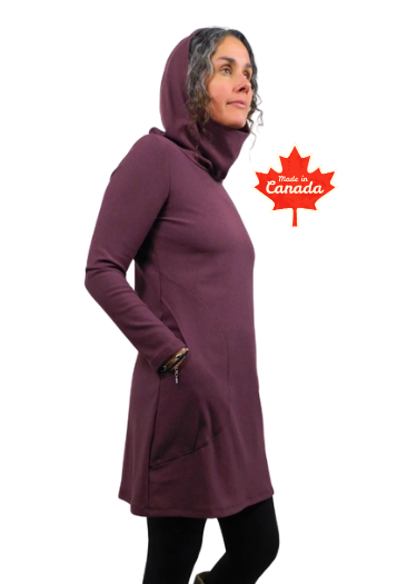Person wearing a long purple coat with a hood, standing next to a Canadian flag icon on a white background.