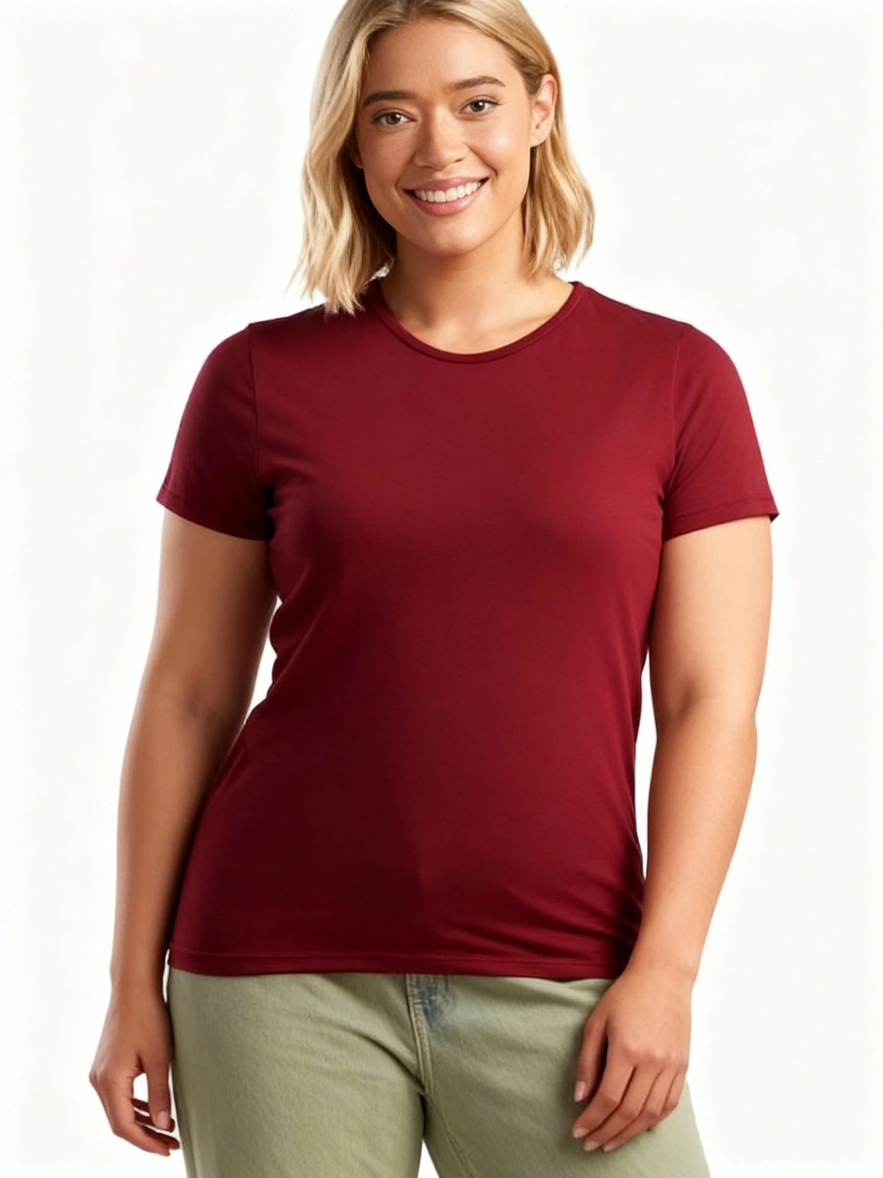 Woman wearing a maroon bamboo clothing t-shirt and green pants on a white background