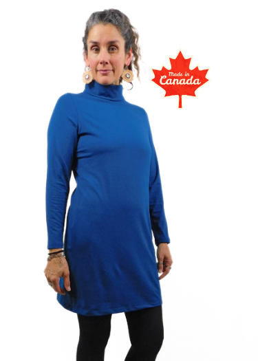 Woman wearing a blue tunic with 'Made in Canada' label on a white background